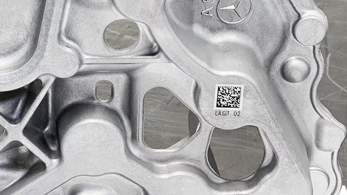 Automotive metal component with laser-marked 2D code for part identification