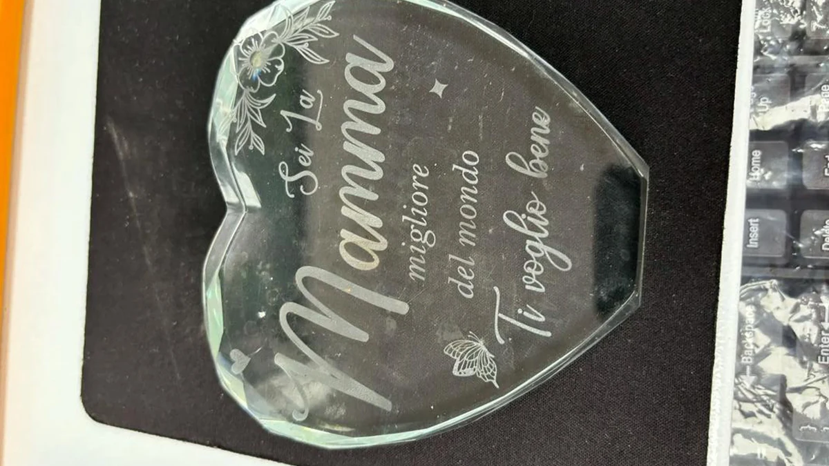 Personalized heart-shaped crystal gift laser marked with names, decorative text and floral graphics.