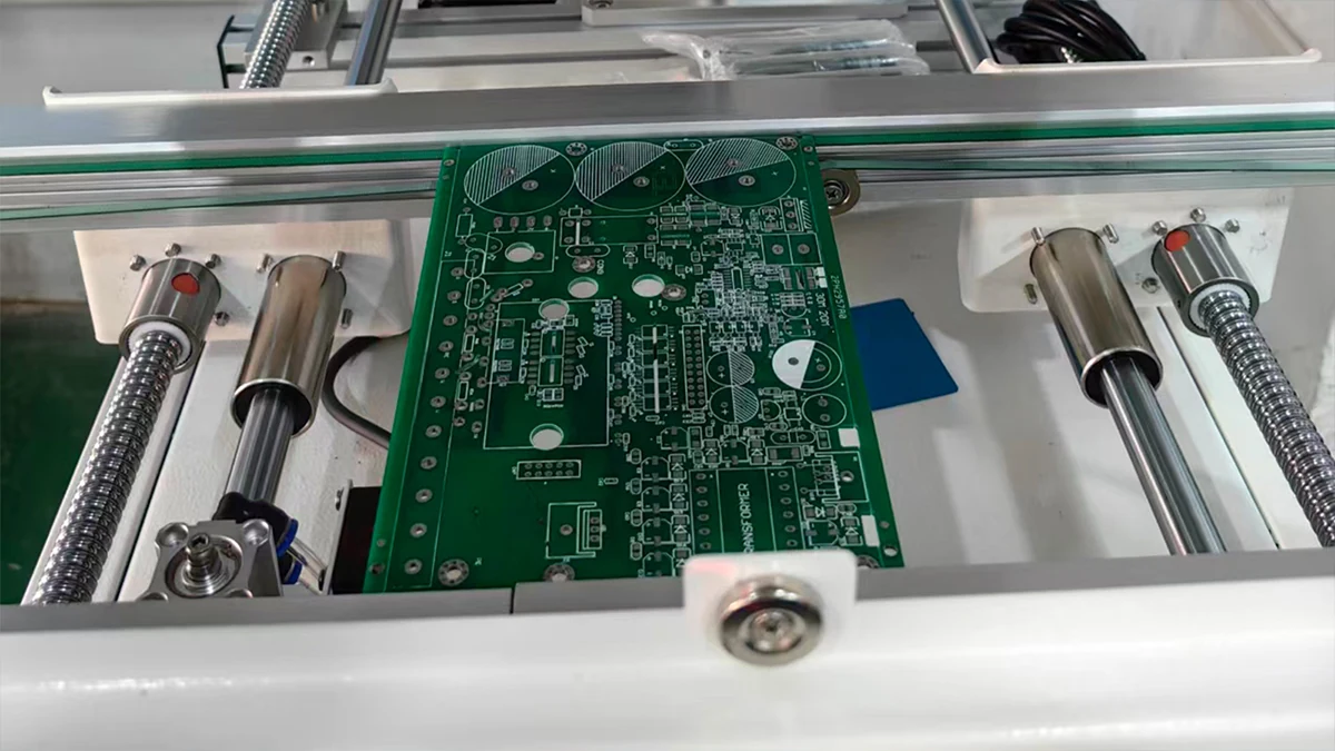 Green PCB panel positioned in a production fixture for repeatable board handling