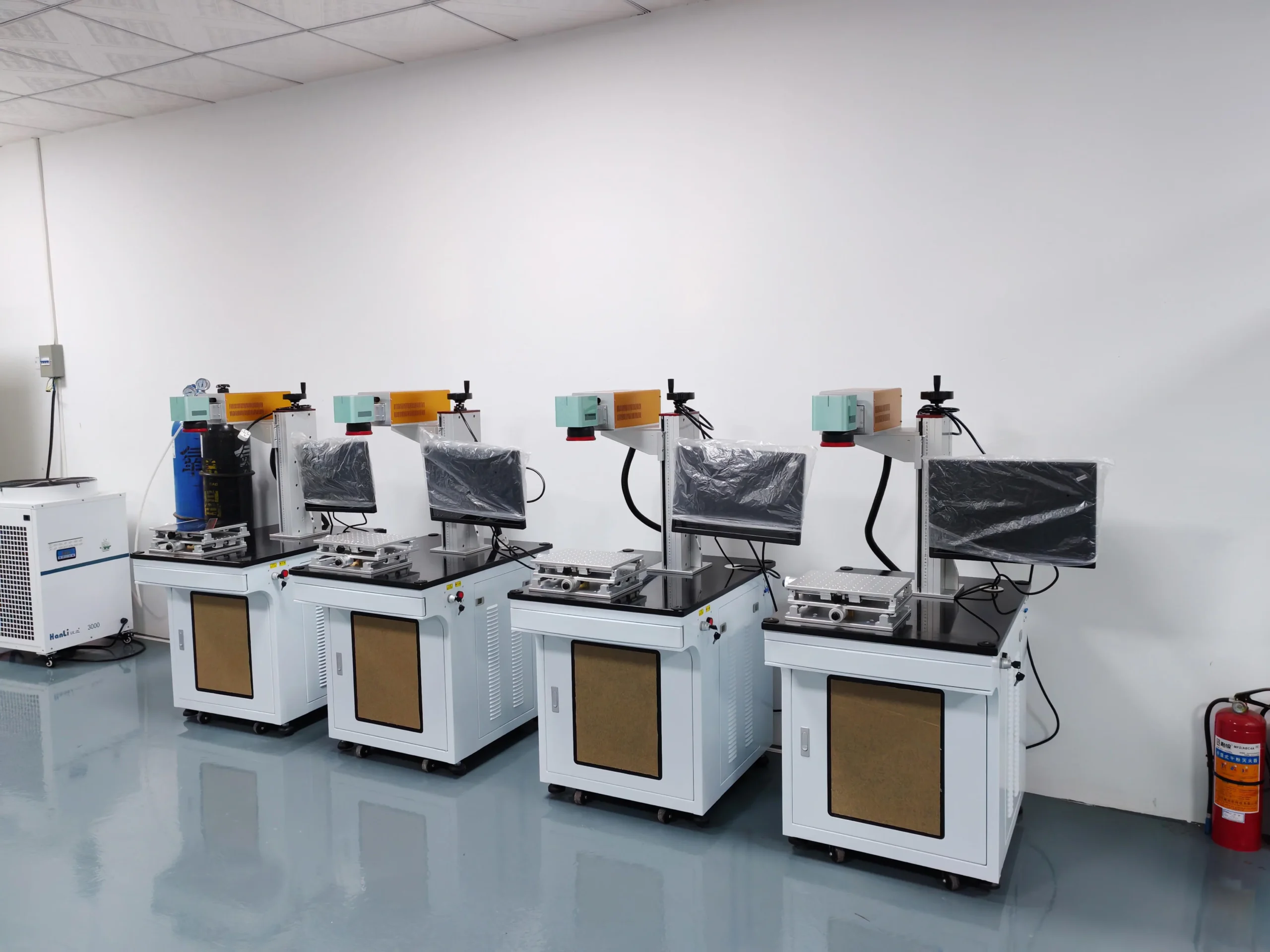 Laser marking machines being assembled and checked in a factory workshop
