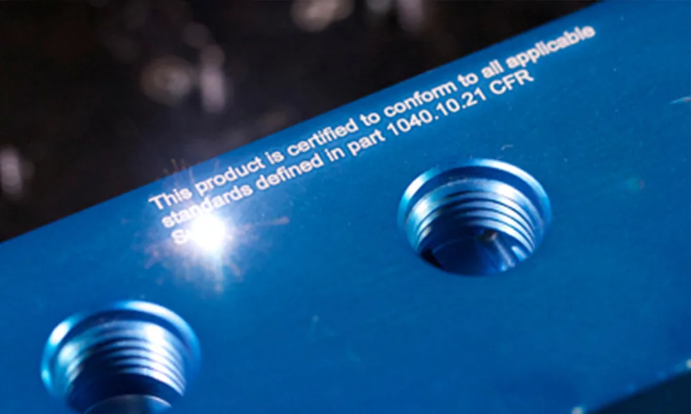 Anodized aluminum plate with laser marked text near threaded holes