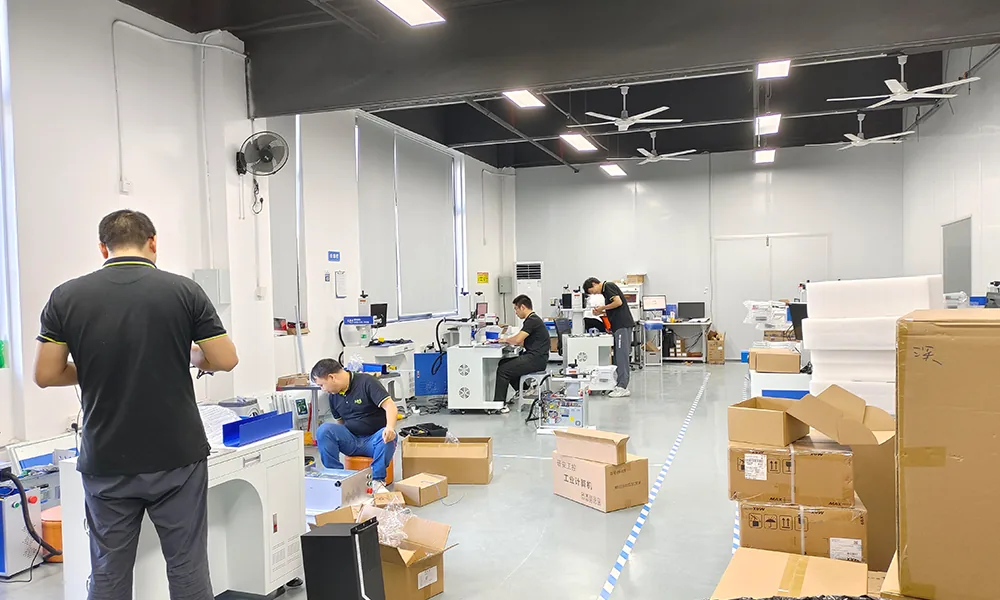 Technicians assembling laser marking machines in the workshop