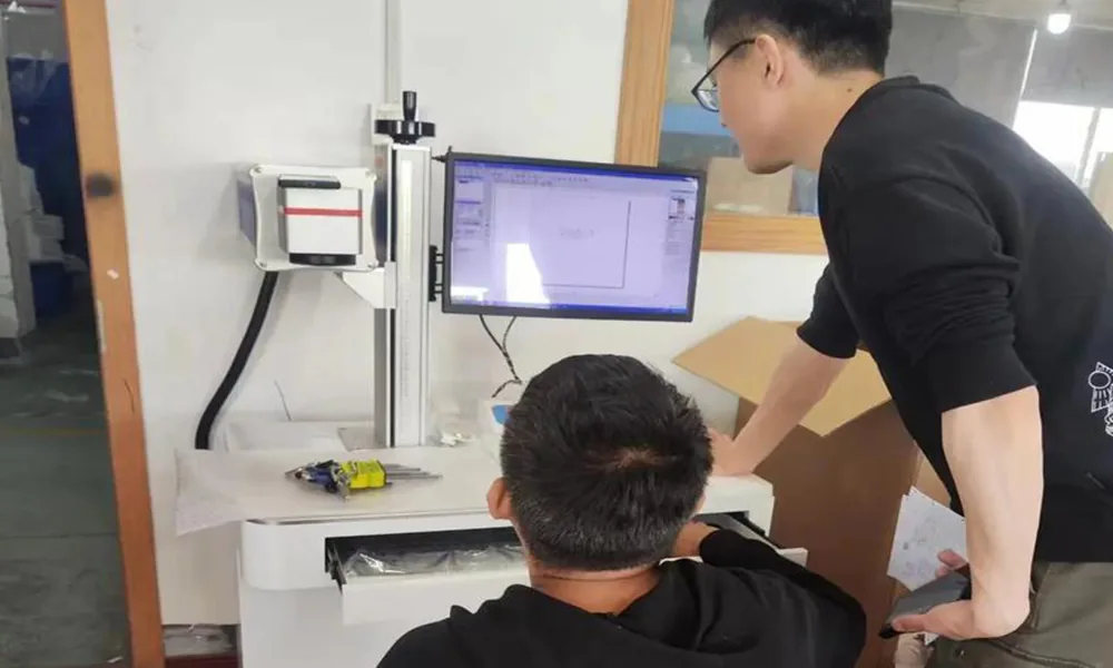 Technicians commissioning a completed laser marking machine