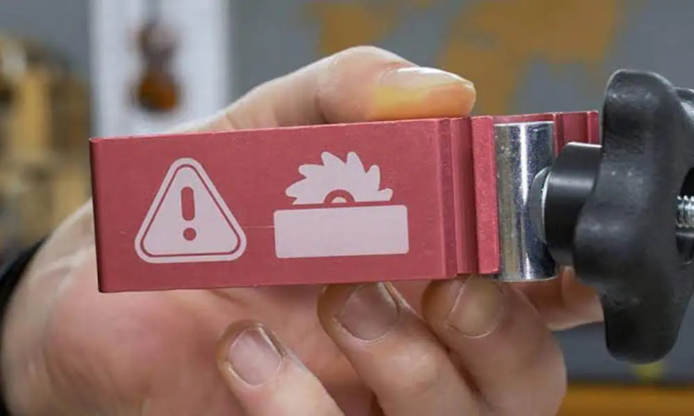 Laser-marked anodized aluminum component with clear safety graphics