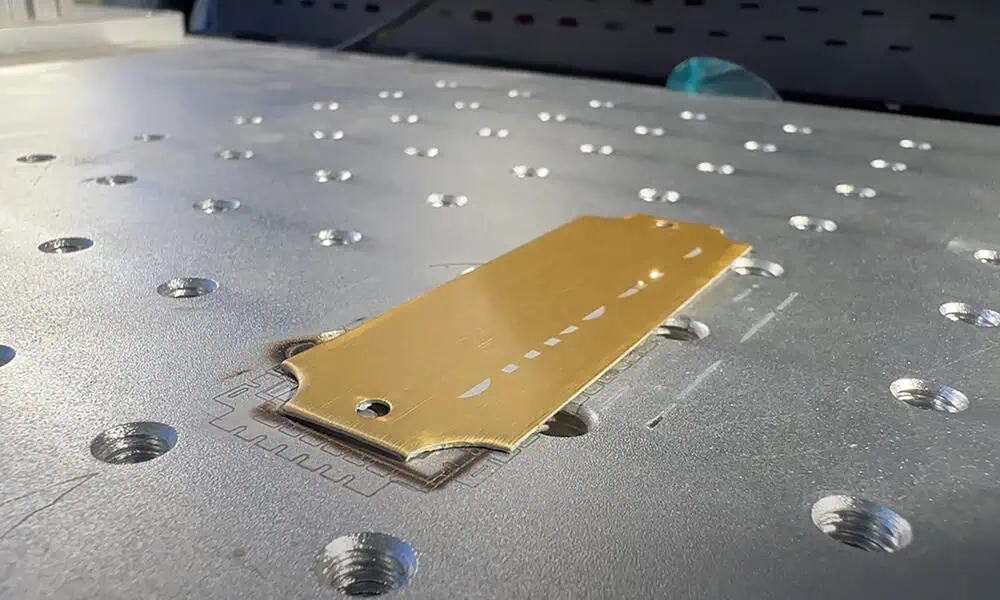 Laser marked decorative butterfly pattern on a gold-colored plate