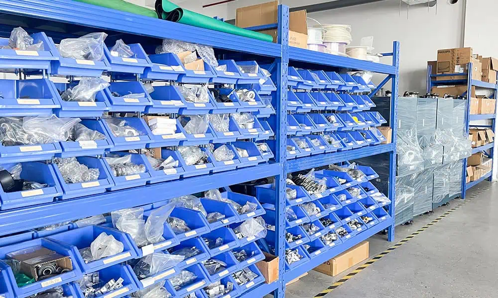 Laser marking machine parts stored on organized factory shelving