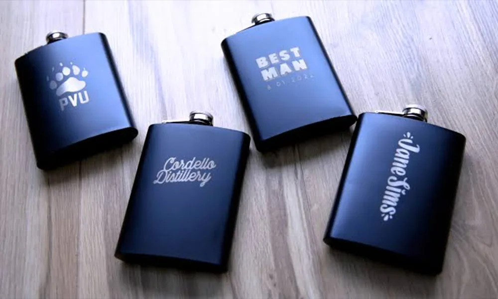 Black coated metal gift flasks with bright laser-marked logos and personalized graphics.