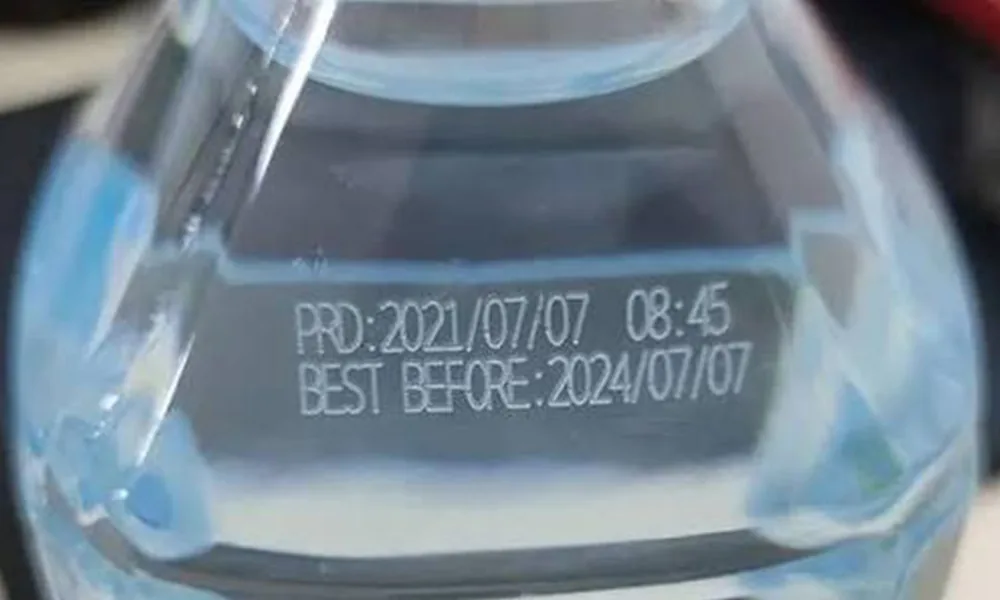 Date and best-before laser code on a transparent PET bottle