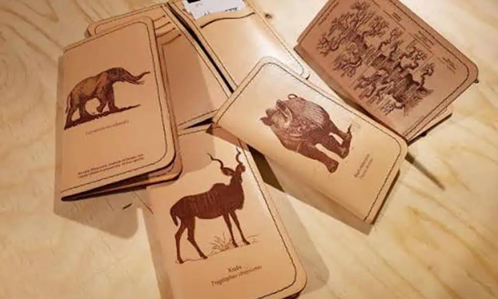 Laser-marked animal and decorative graphics on leather notebook covers and tags