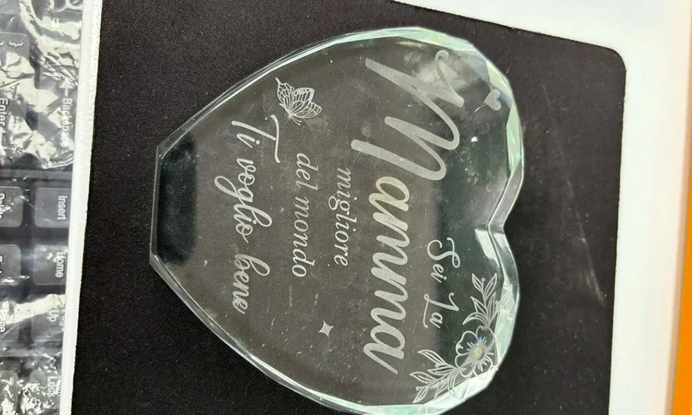 Personalized crystal plaque with visible laser-marked text and decorative graphics